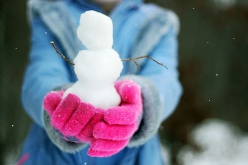 girl, little snowman and snow