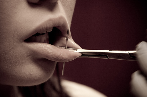 tongue piercing needles. lip piercing needle. hold,