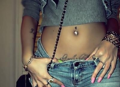 belly button ring,  bracelets and  crop top