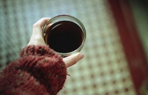 cup, hand and jumper