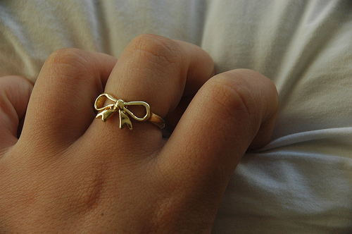 bow, gold and hand