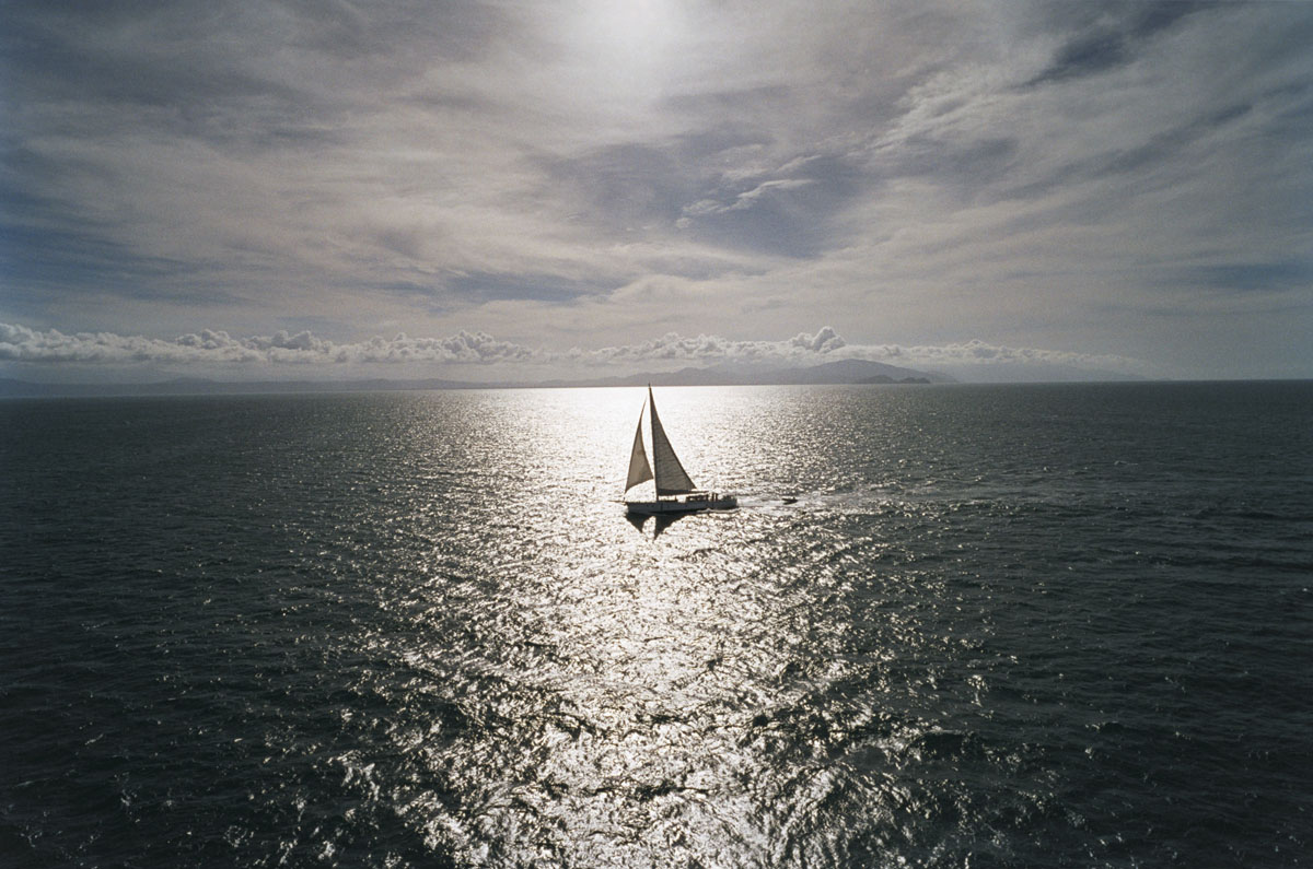 light, ocean and sail boat