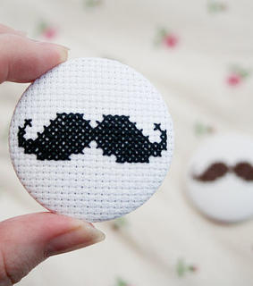 badge, button and cross stitch